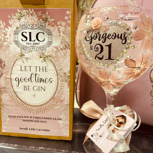 Decorative hand painted and embellished glass with 'Gorgeous at 21' text and embellishments next to a box with 'SLC' branding and text.