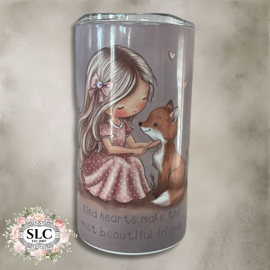 An insulated tumbler with a printed illustration of a girl in a pink dress sitting with a brown fox, on a soft beige textured background. The tumbler has a clear lid and the phrase 'kind hearts make the most beautiful friends' printed near the bottom.